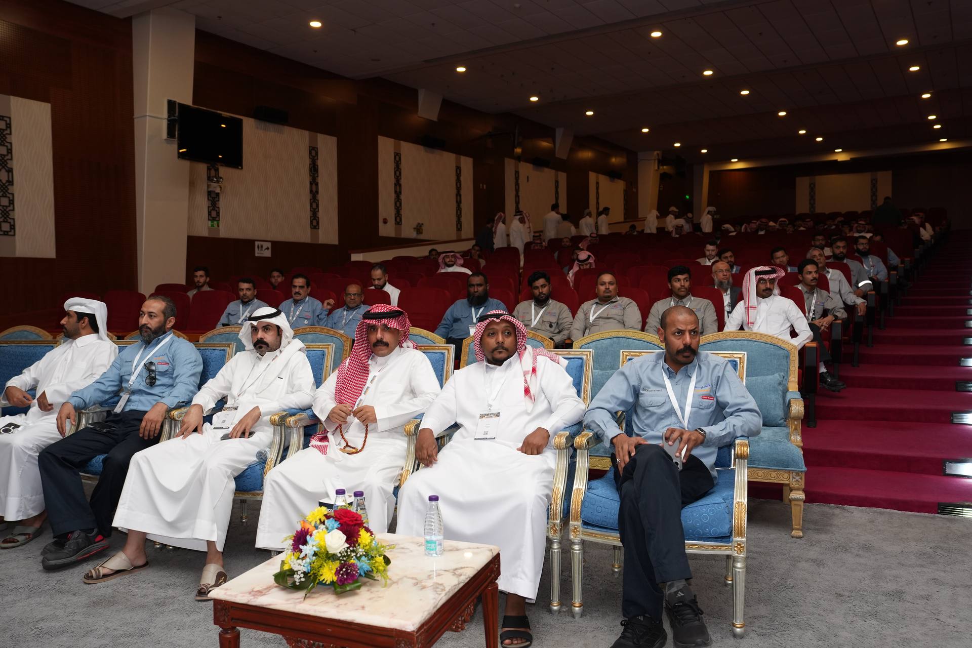Exhibitor showing pipeline fittings to a group of attendees