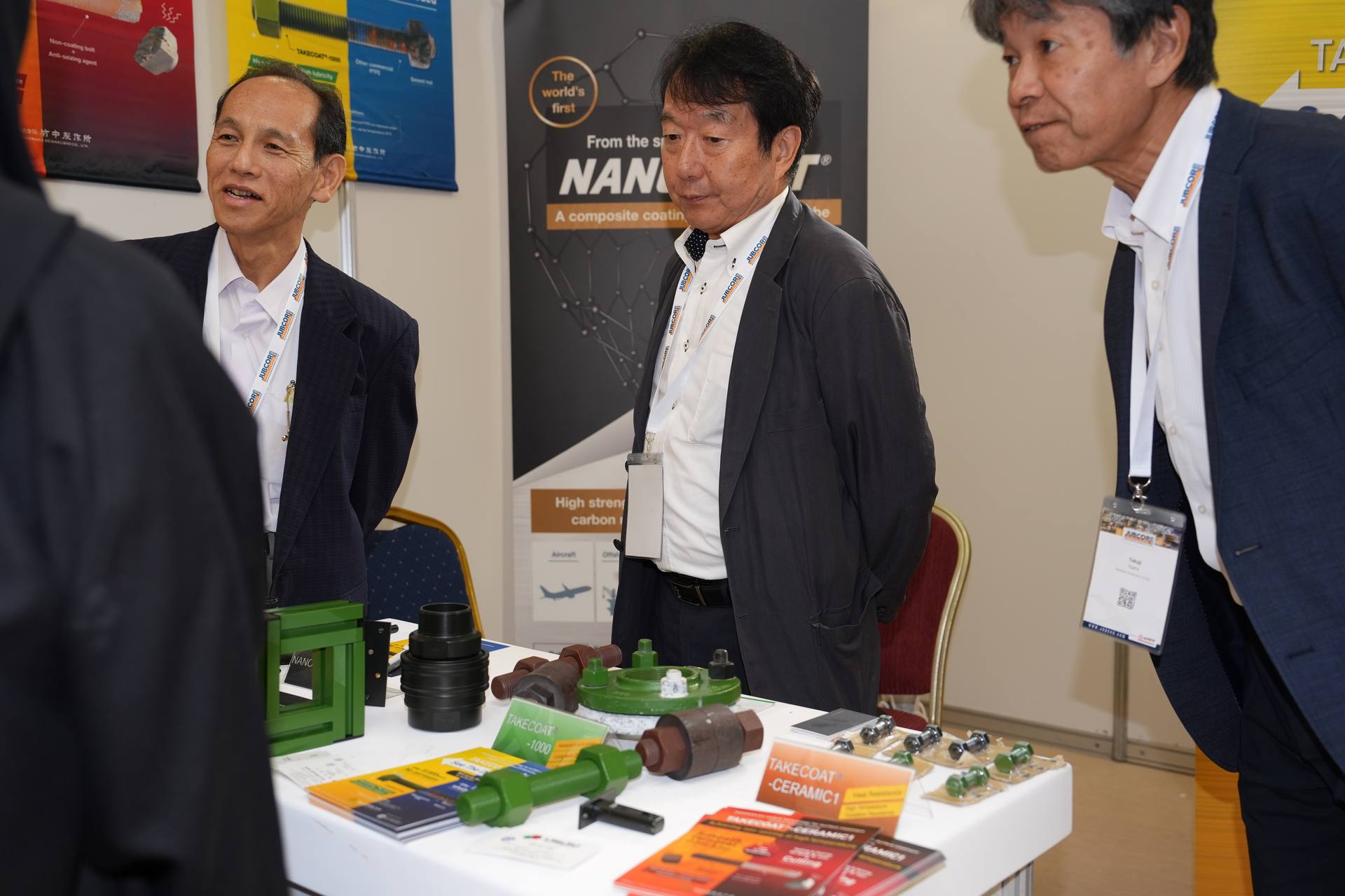 Exhibitor demonstrating pipe inspection equipment to attendees