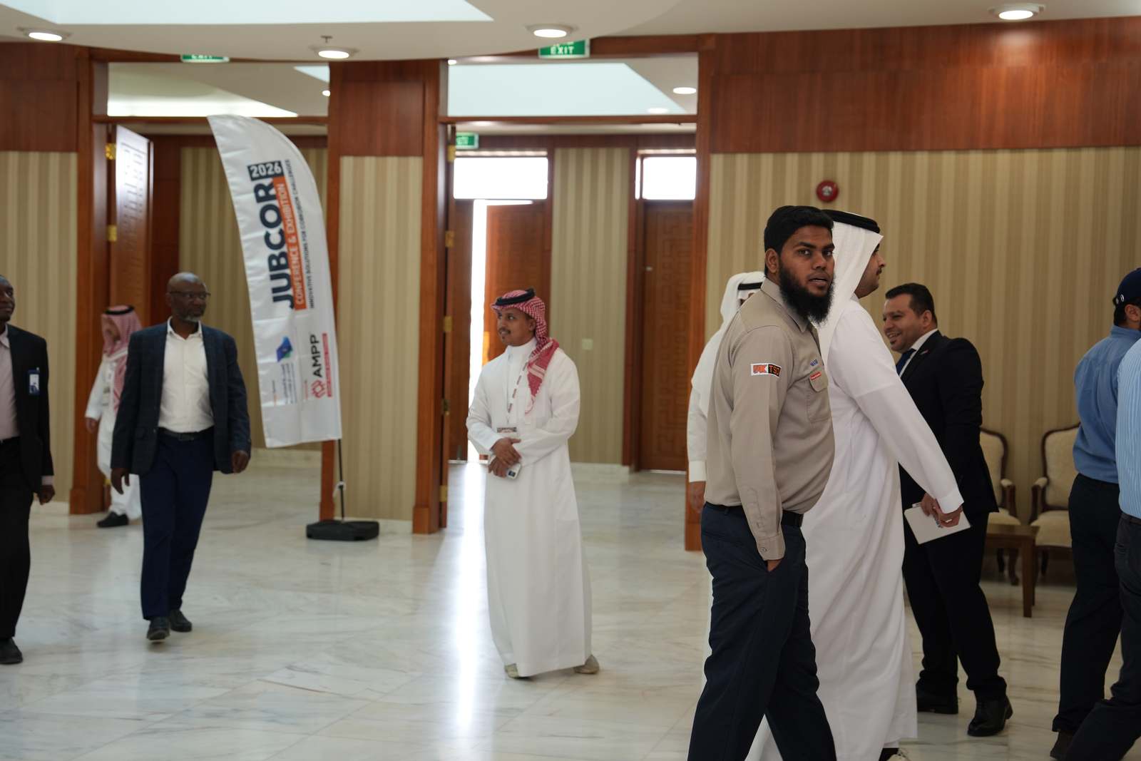 Delegates walking through the exhibition hallway