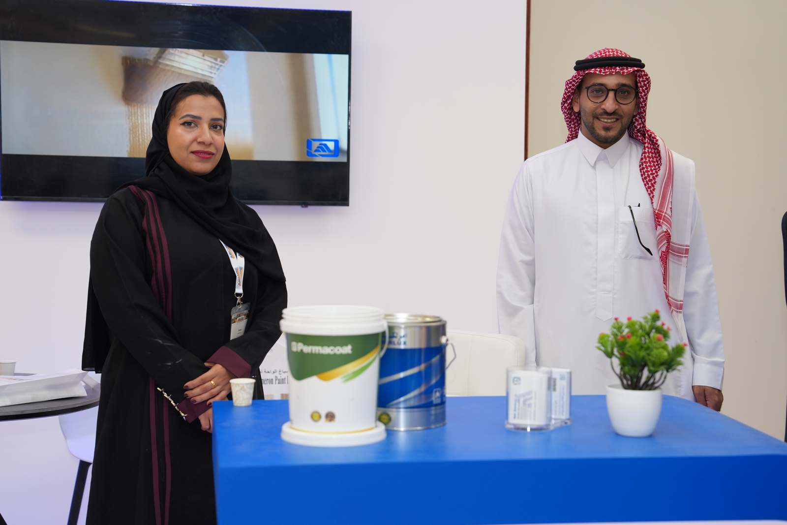 Exhibitor presenting paint products at the booth