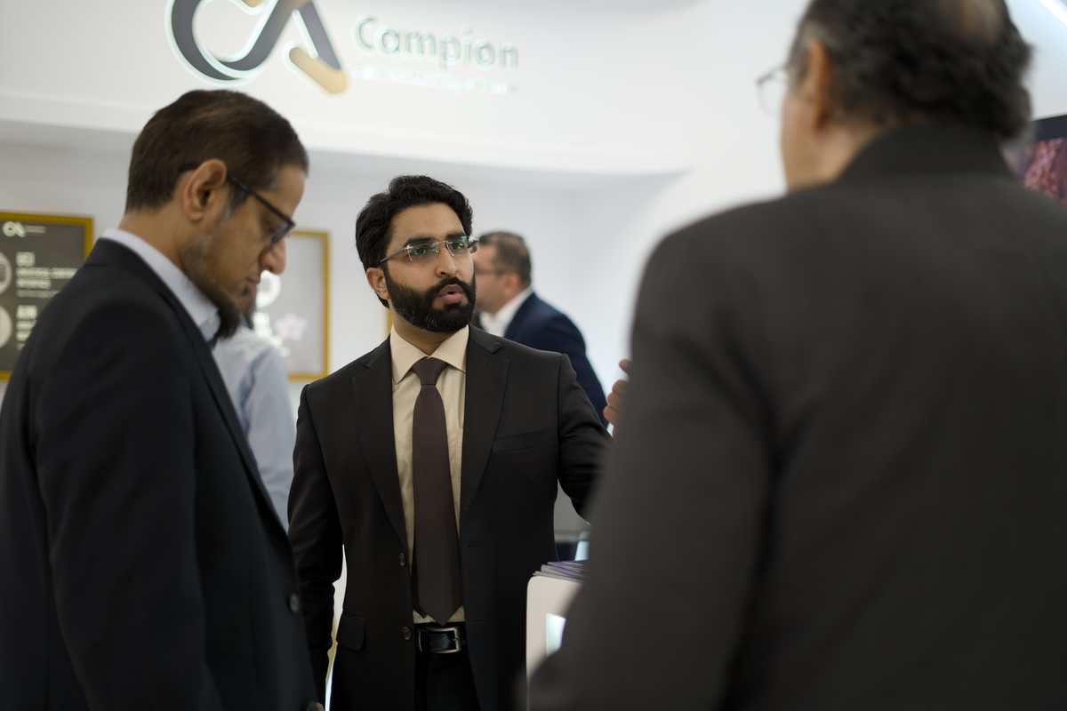 Attendee discussing a product with an exhibitor representative