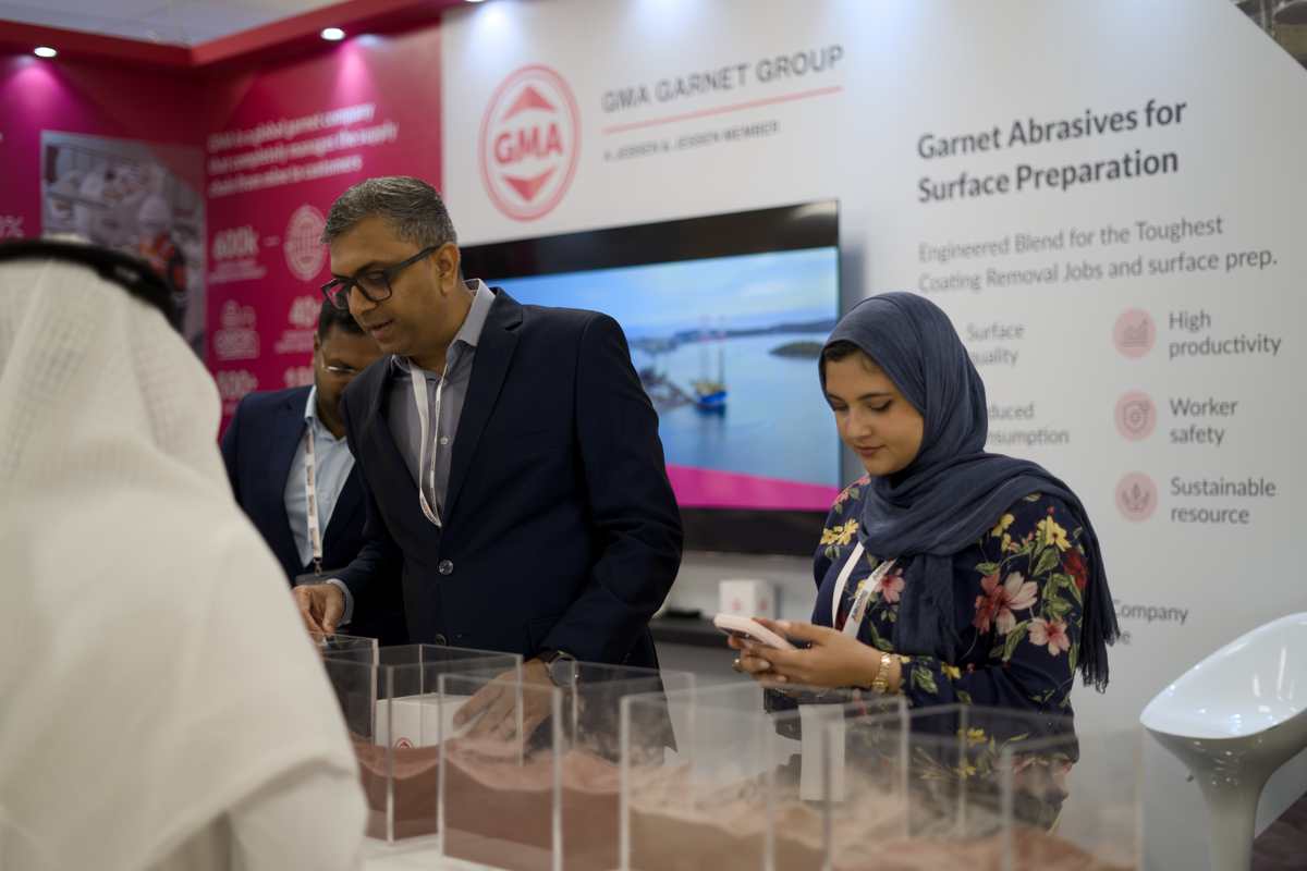 Visitors at the GMA Garnet Group booth examining sample displays