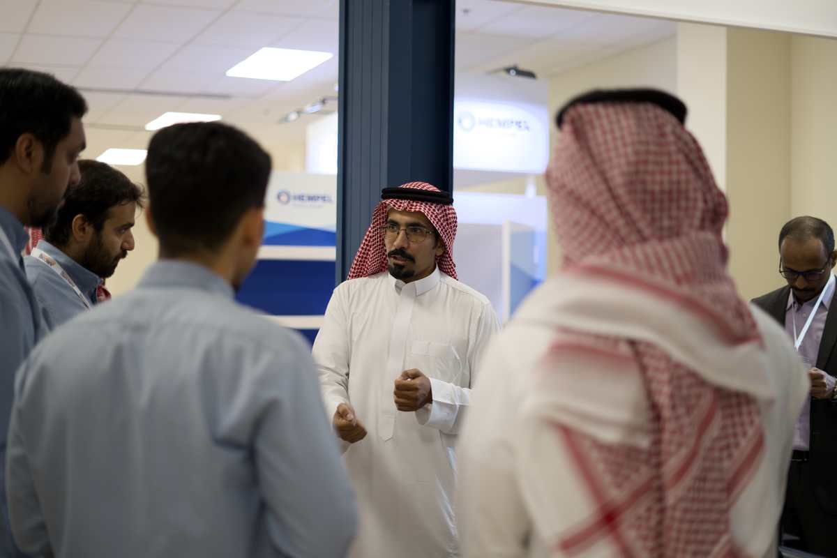 Delegate speaking with attendees near the Hempel booth