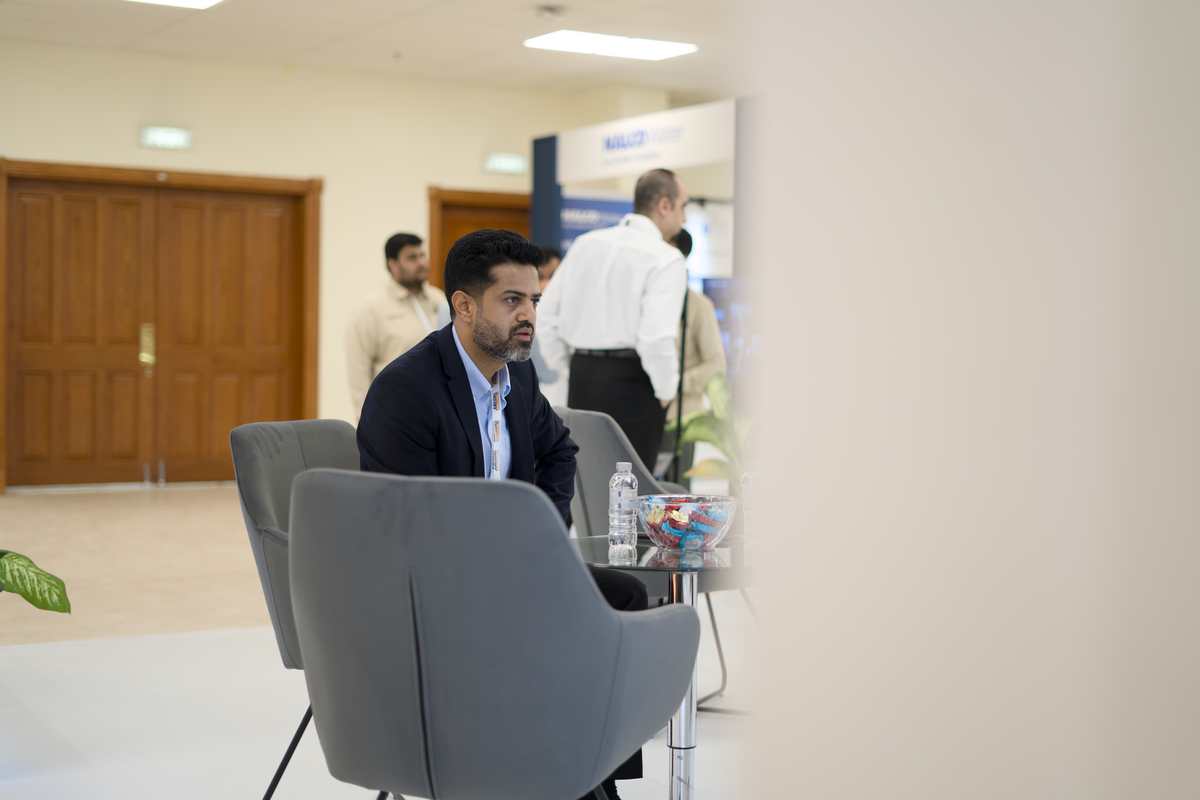 Attendee seated in the networking lounge area