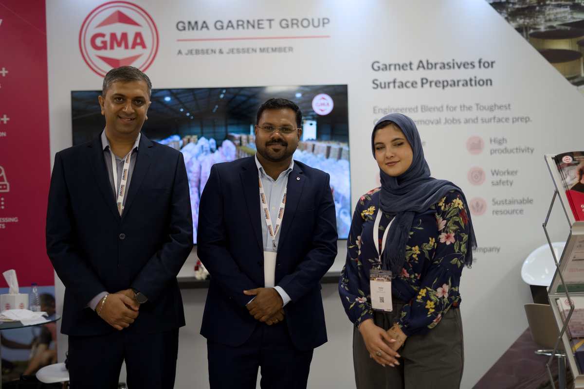 GMA Garnet Group team members posing at their booth